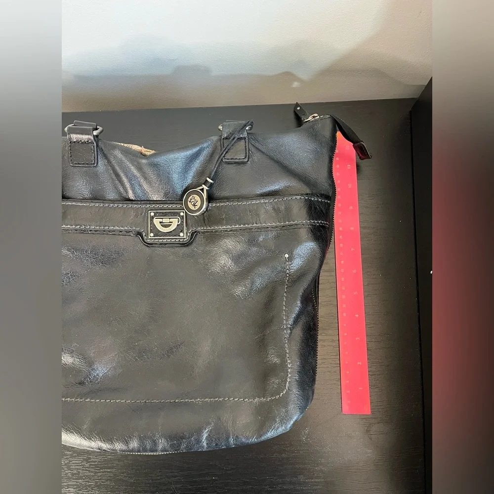 The Sak Expandable Black Leather Suede Shoulder Tote Bag with Suede Tassels